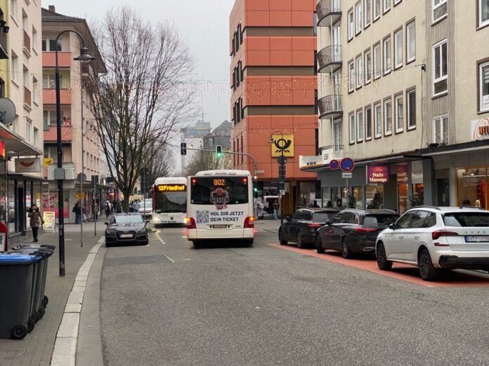 Normalität in der Fahrradzone: Autos zu beiden Seiten, Busse und Radfahrende werden behindert. Im Bild sind die laut VCD falsch angeordnete Ladezone (rechts) und der Taxistand (links) zudem wieder einmal mit Falschparkern belegt.